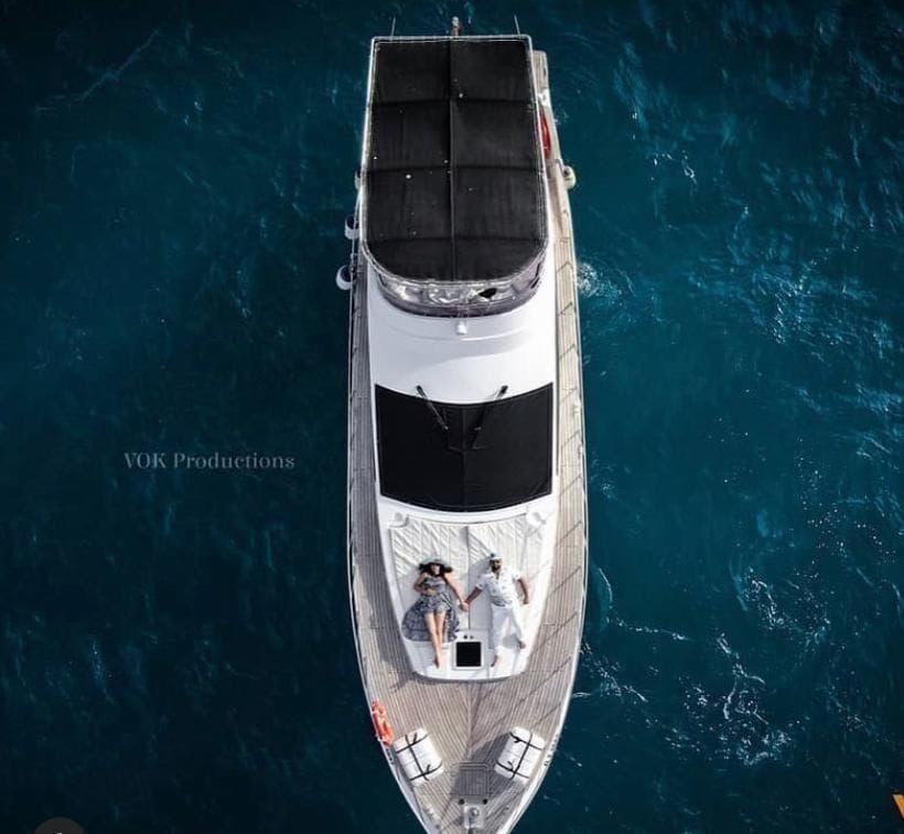 Couple on teak yacht foredeck